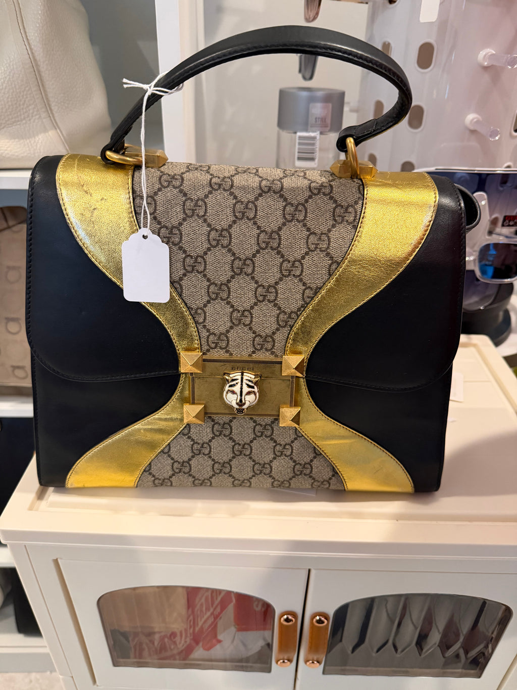 Gucci Osiride Medium GG Supreme top-handle bag in black leather and gold-tone hardware.