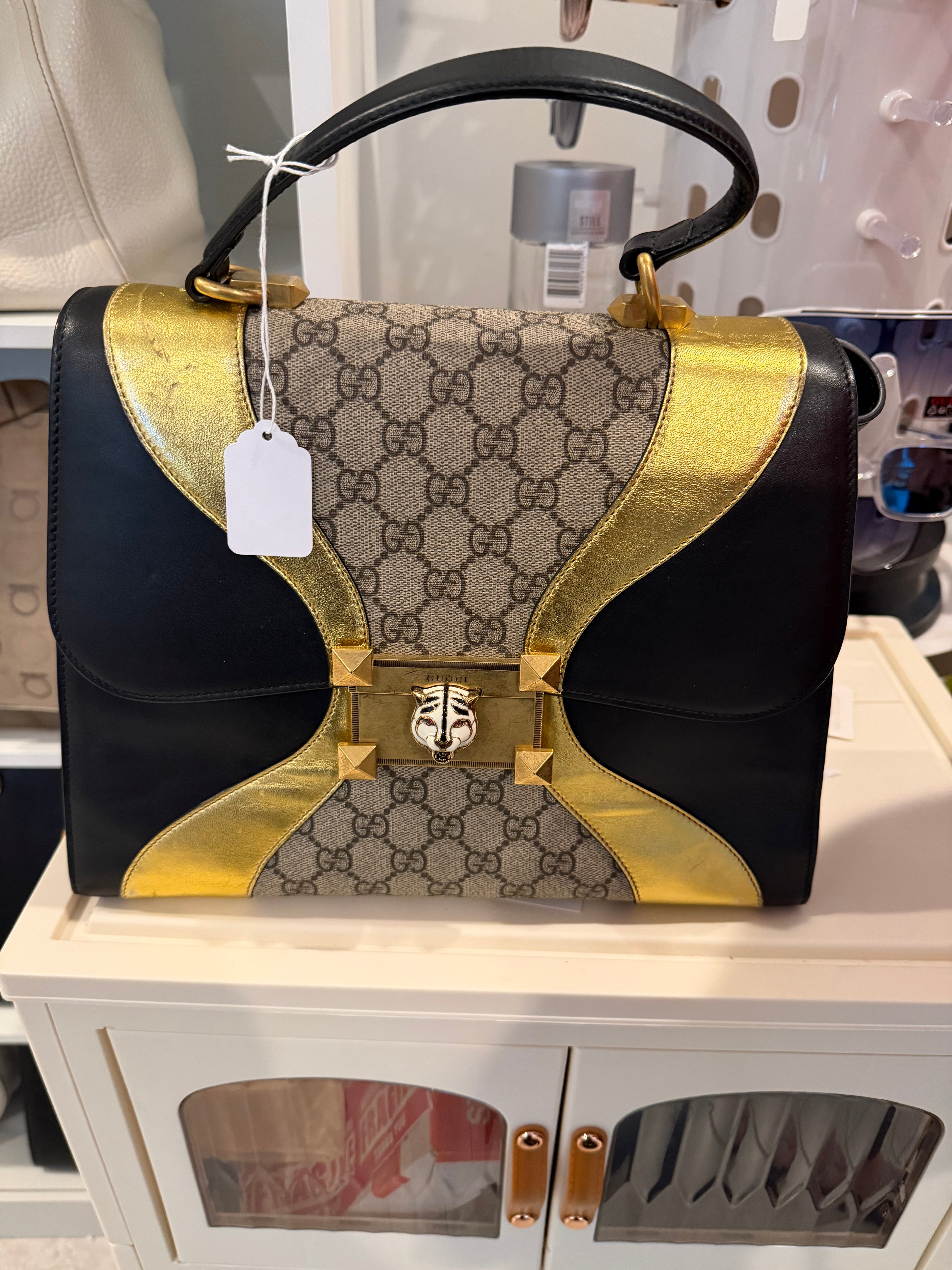 Gucci Osiride Medium GG Supreme top-handle bag in black leather and gold-tone hardware.