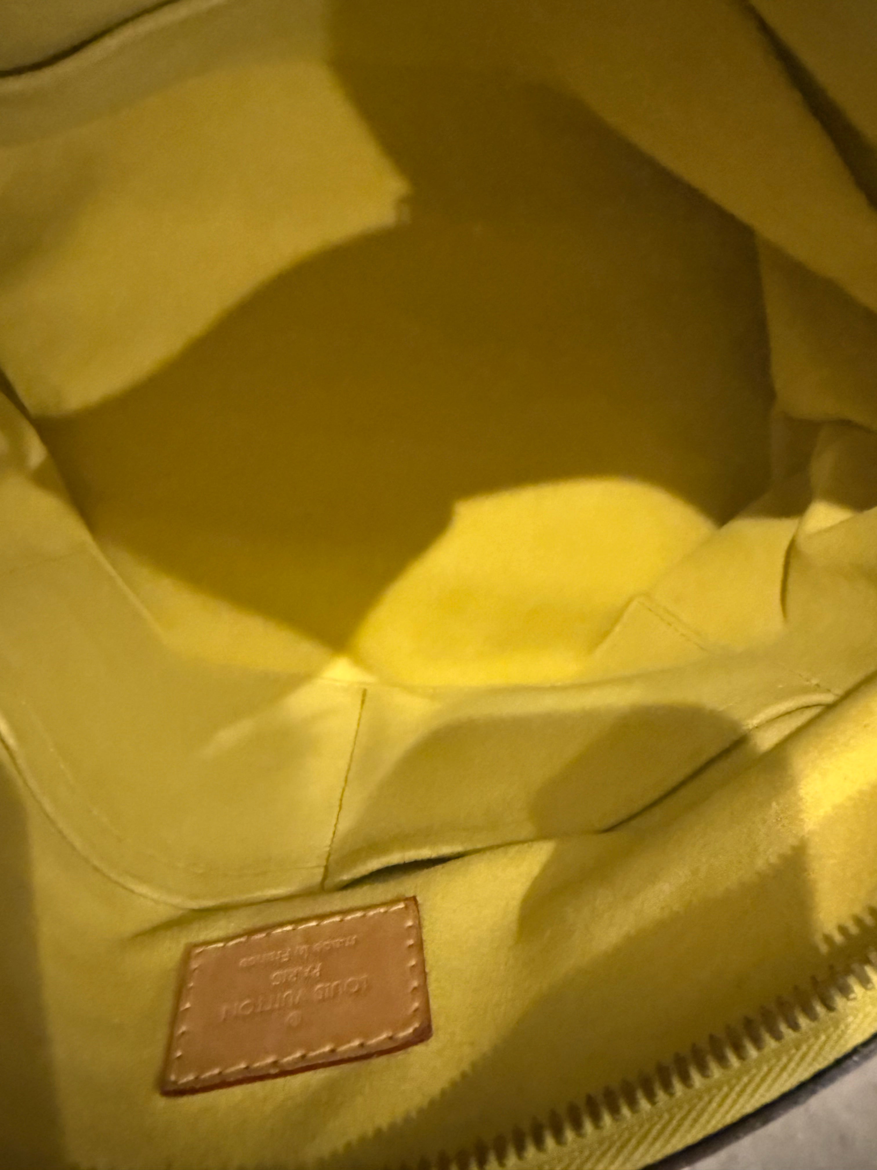 Louis Vuitton Pallas in the Monogram canvas with a yellow/saffron color accent and lining.