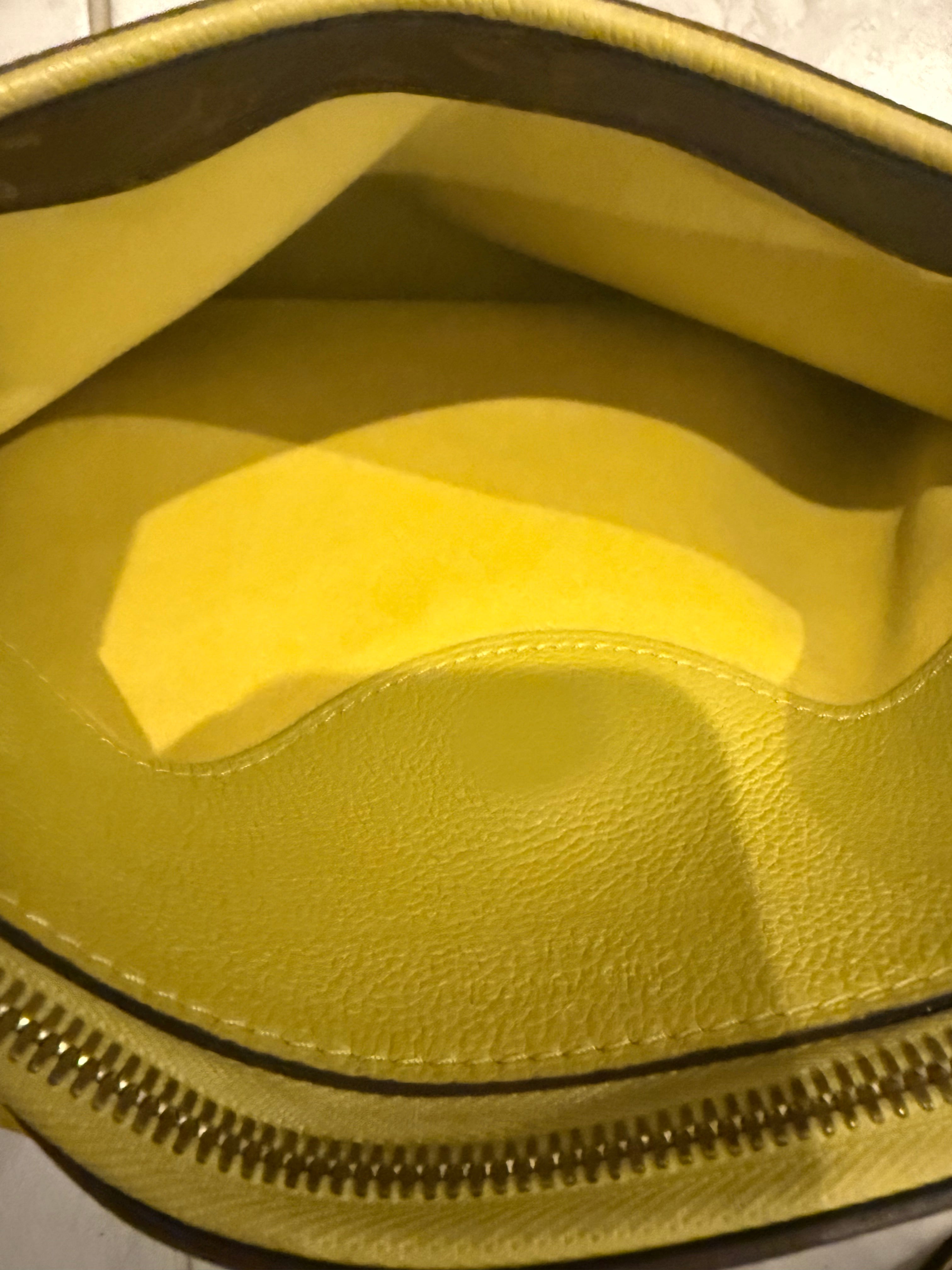 Louis Vuitton Pallas in the Monogram canvas with a yellow/saffron color accent and lining.