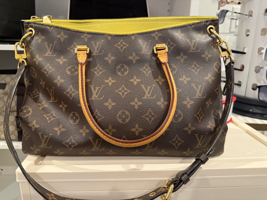 Louis Vuitton Pallas in the Monogram canvas with a yellow/saffron color accent and lining.