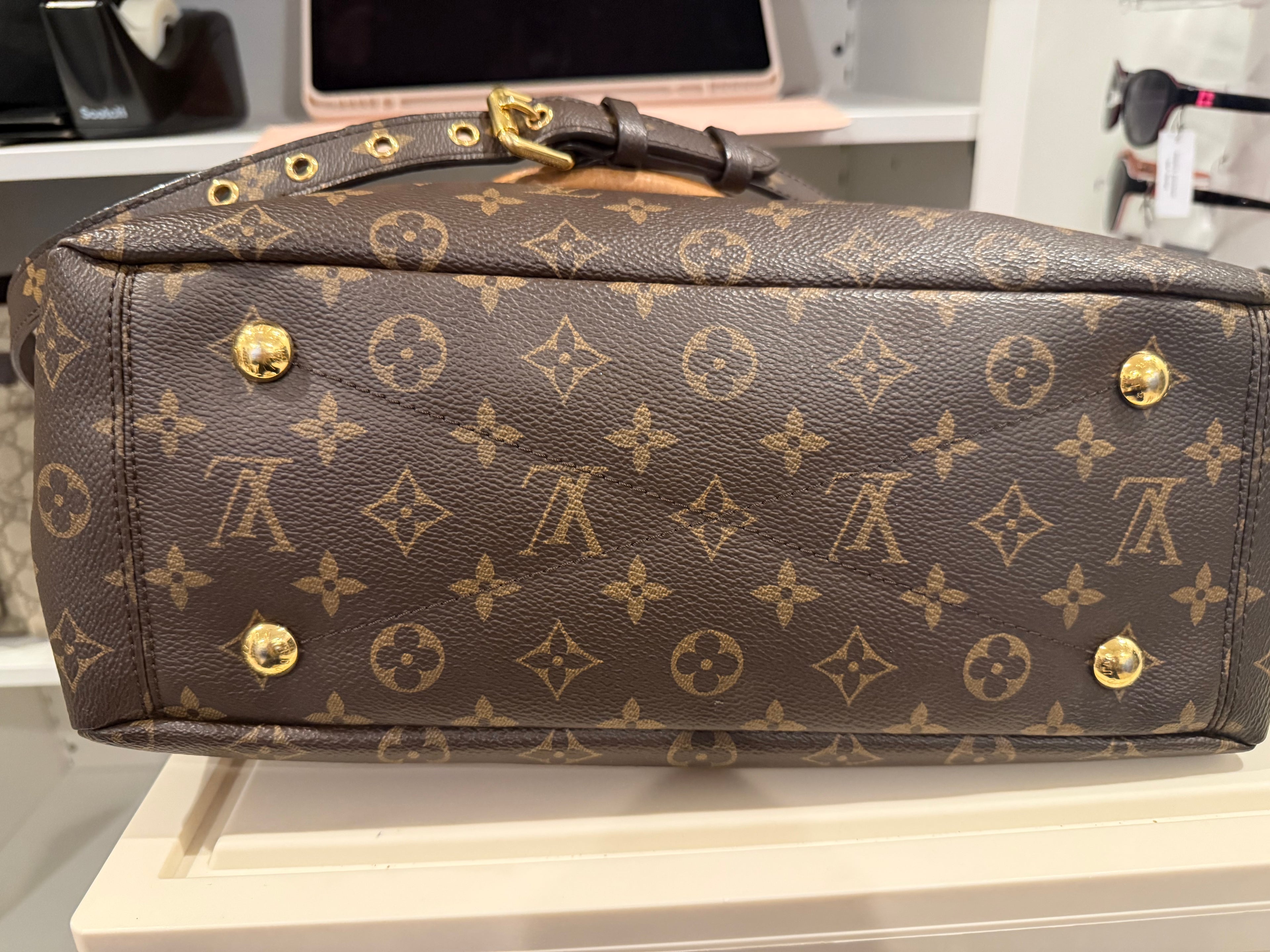 Louis Vuitton Pallas in the Monogram canvas with a yellow/saffron color accent and lining.