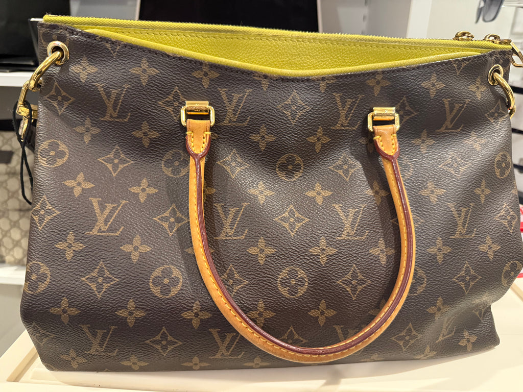 Louis Vuitton Pallas in the Monogram canvas with a yellow/saffron color accent and lining.